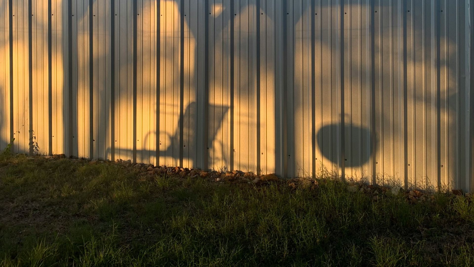 a shadow of a bicycle on a metal wall