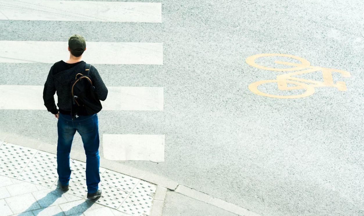 a man standing in front of a crosswalk