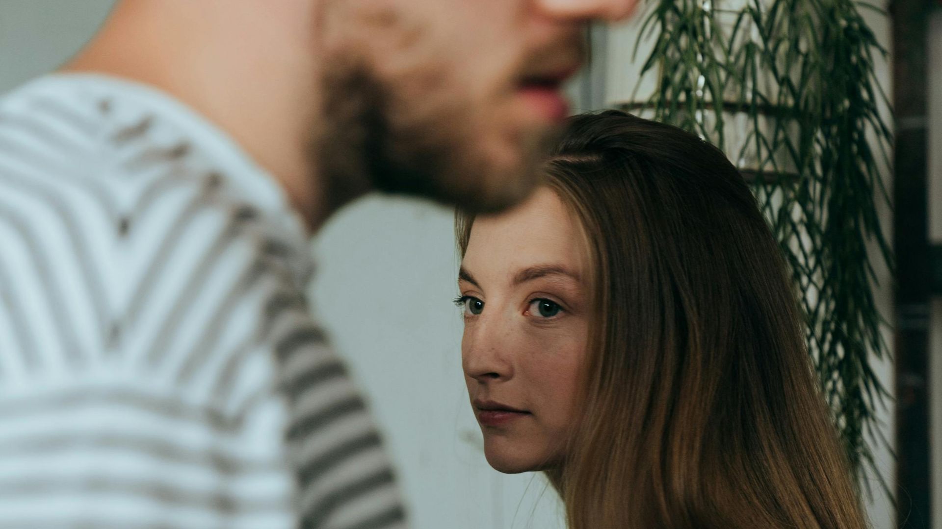 Contemplative couple indoors, stylish and thoughtful setting.