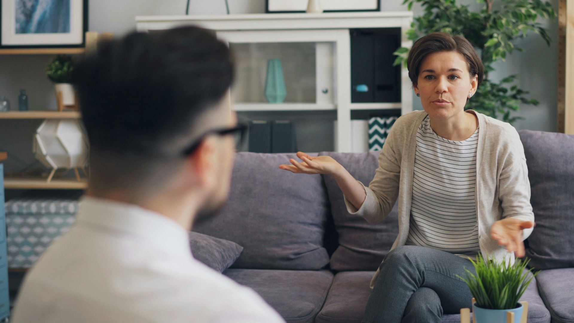 A woman consulting with a professional therapist in a modern office setting.