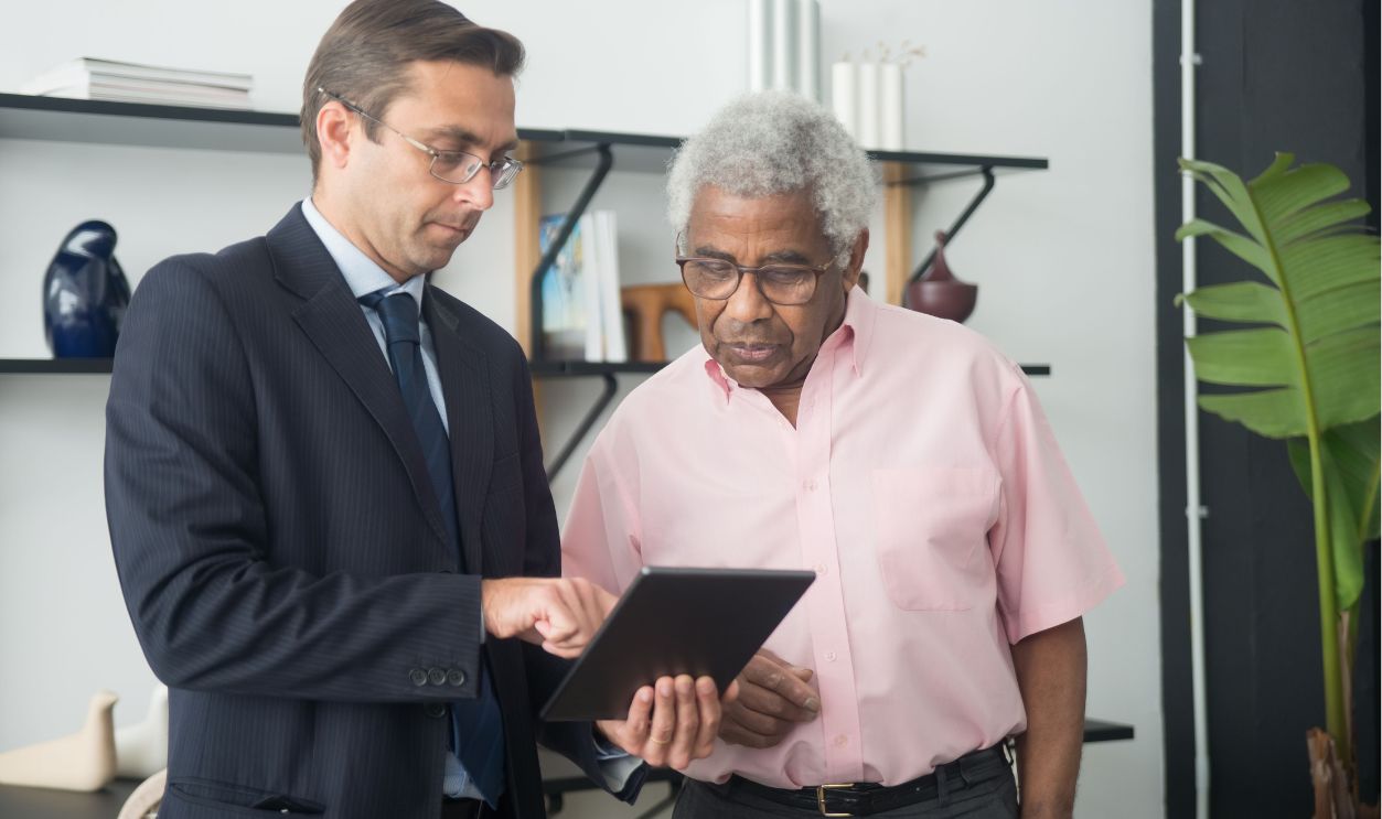 Two men discussing business strategies using a digital tablet 