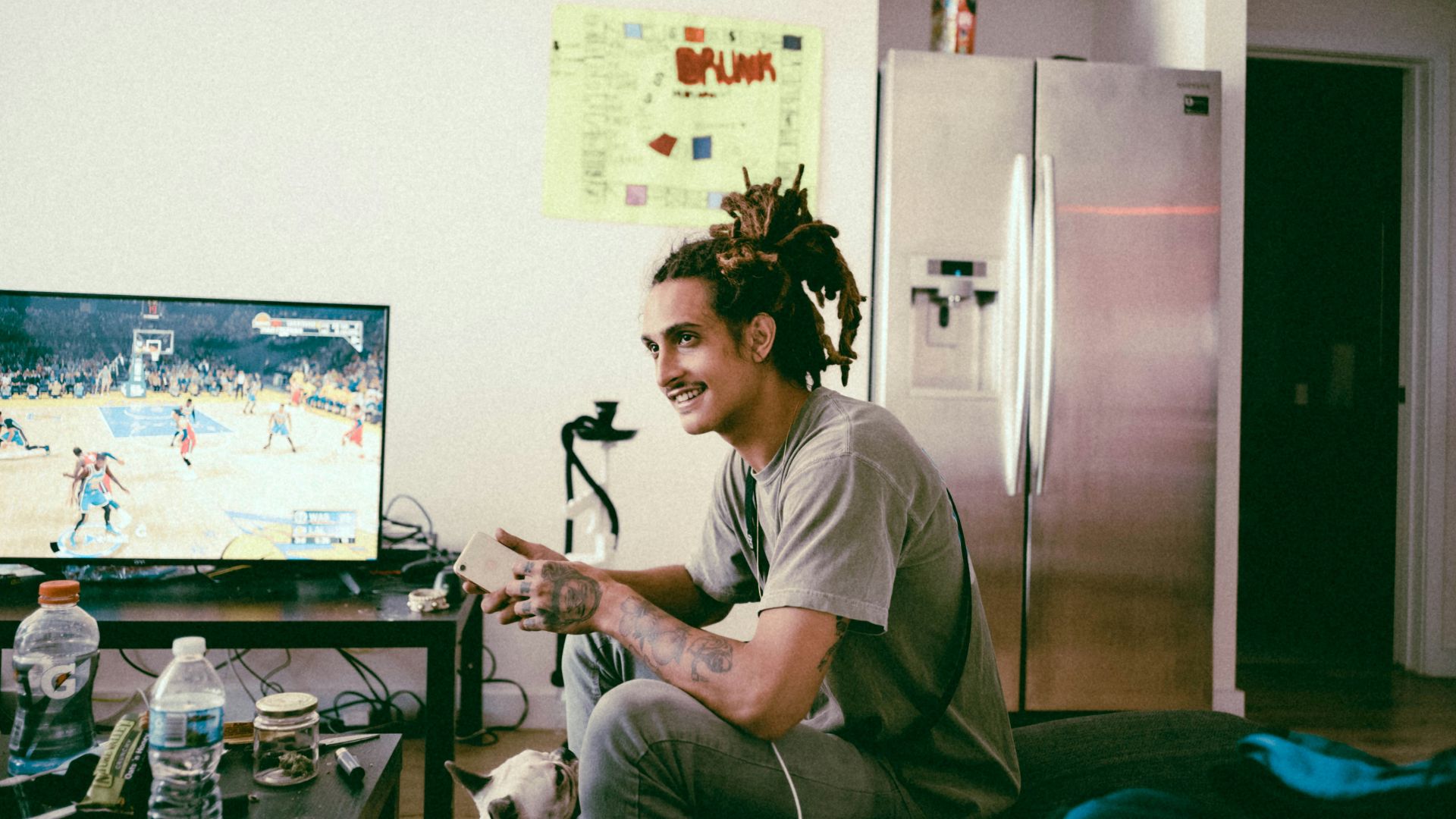 a man sitting on a couch in front of a tv