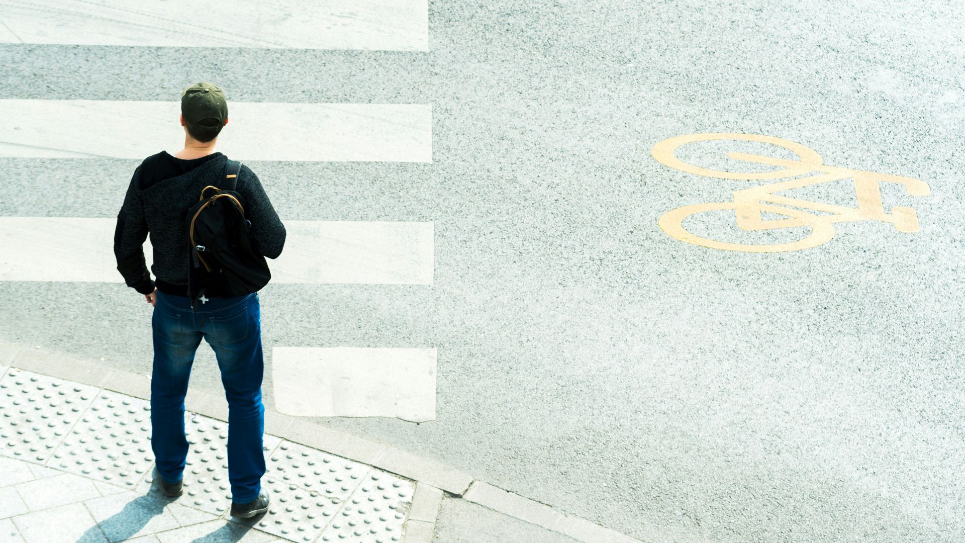 a man standing in front of a crosswalk