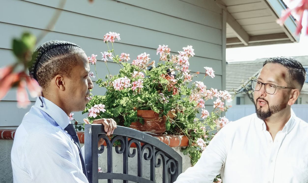 A friendly handshake between two men, symbolizing a successful real estate deal