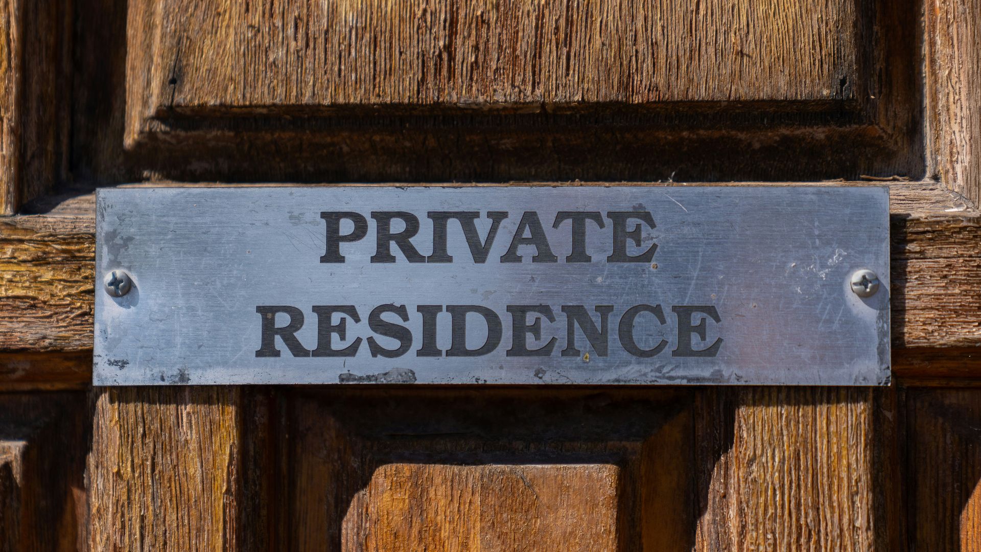 Private residence sign on wooden door
