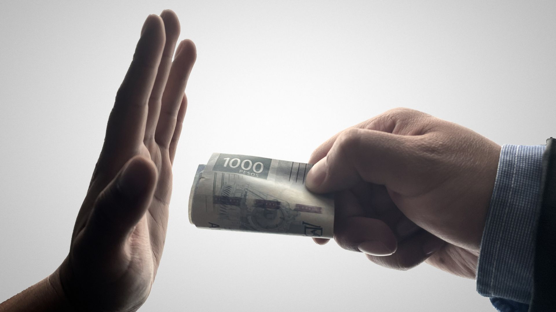 a person holding a stack of cash