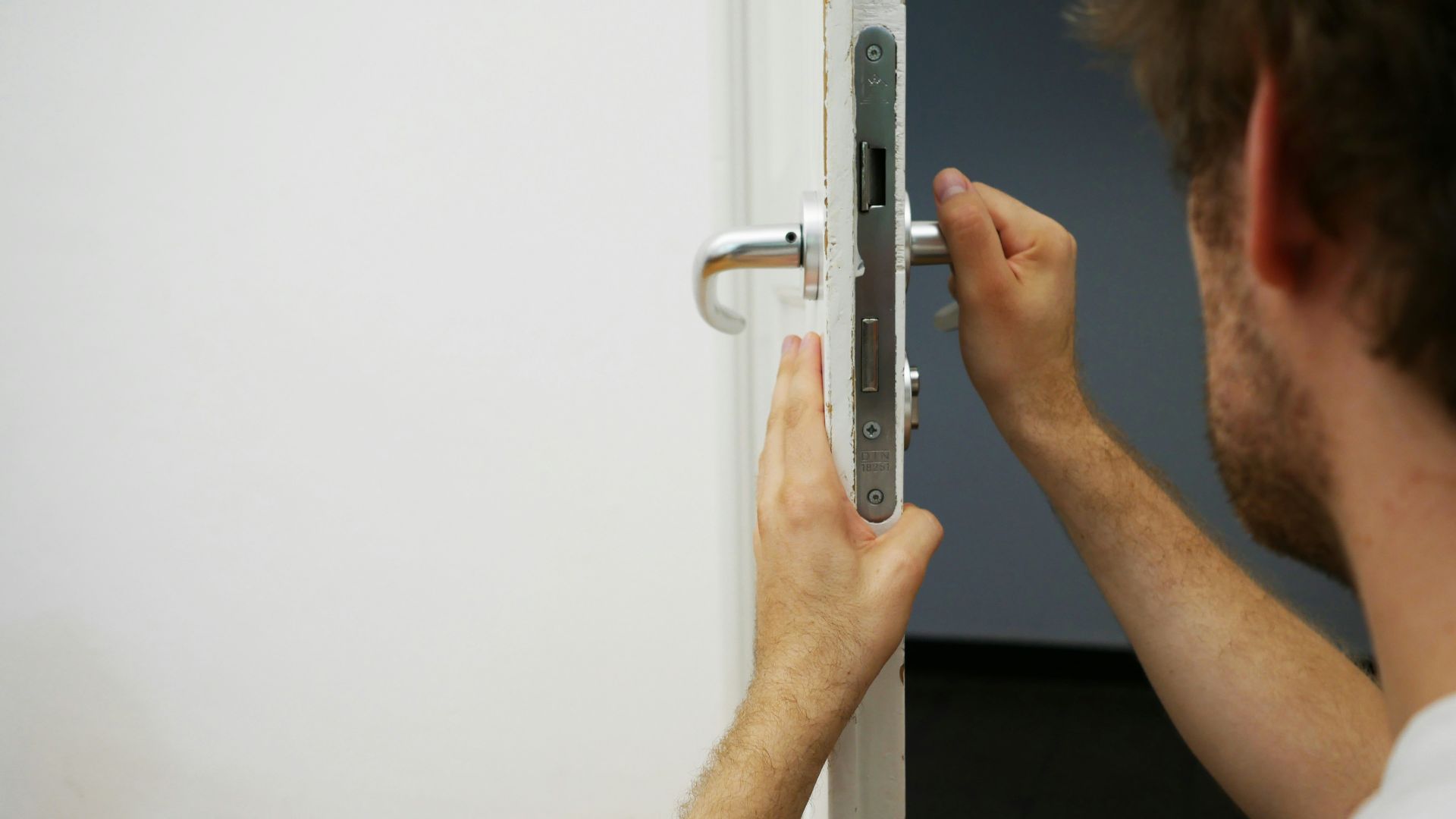 person holds door lever