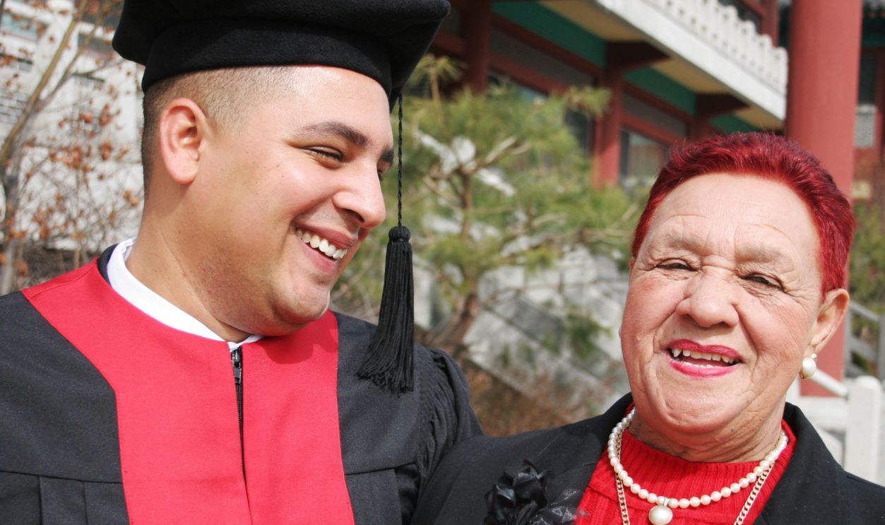 University graduate shares a moment with his grandmother - happy and successful