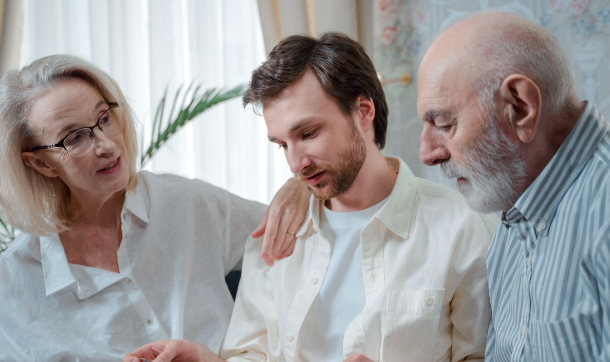 A family looks through a photo album, cherishing memories together indoors