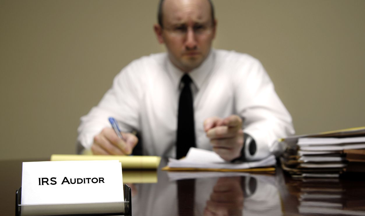 IRS tax auditor man with a stern or mean expression