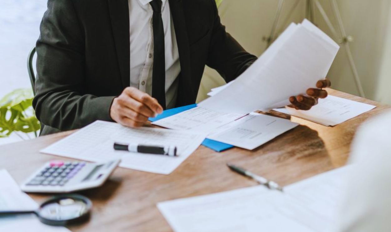Professional businessman reviewing documents at a desk in a modern office setting