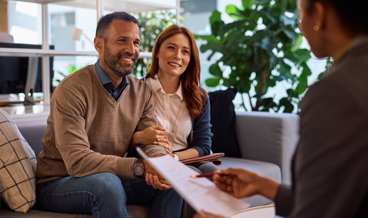 Happy couple having consultations with insurance agent in the office.