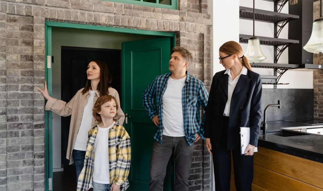 Family exploring potential new home guided by a real estate agent