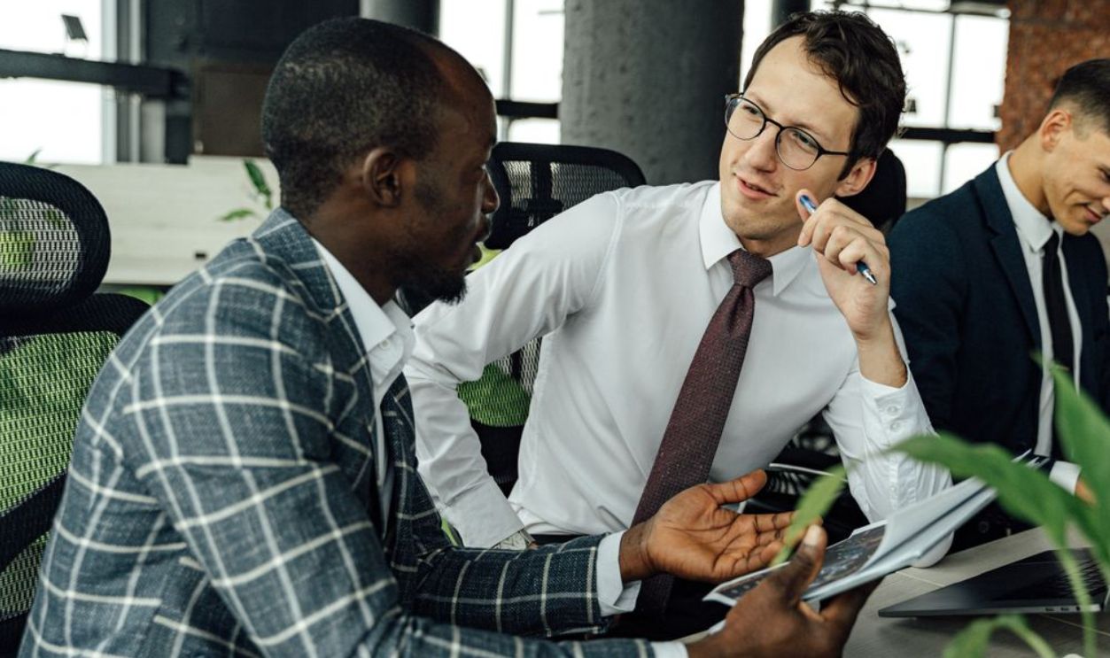Multicultural business team in a lively discussion around a conference table