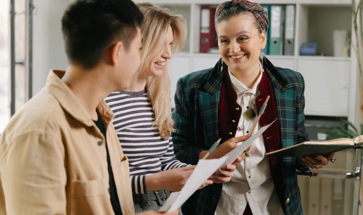 A group of diverse young adults discussing and planning in an office environment
