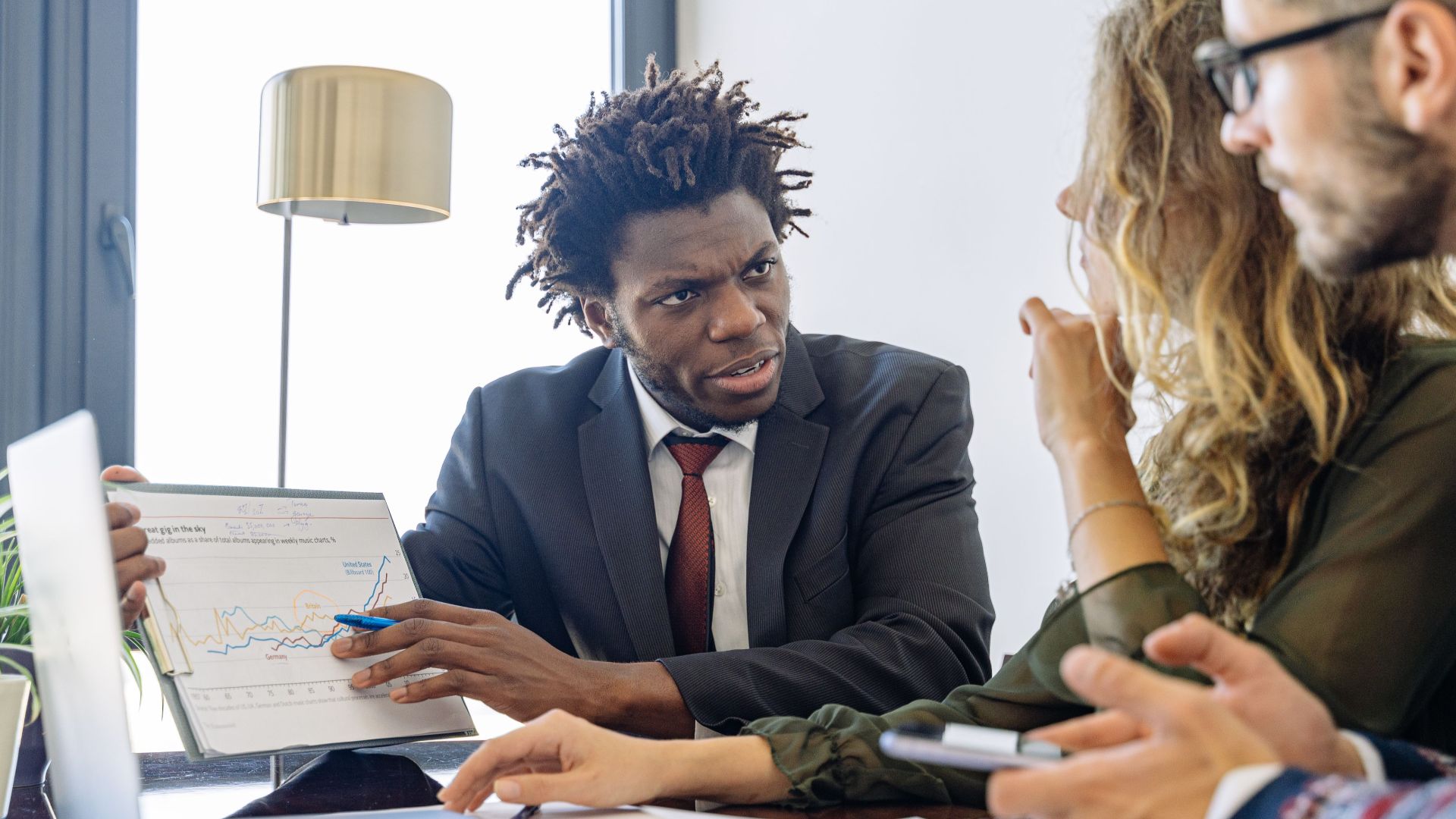 Business professionals discussing financial data during a collaborative meeting.