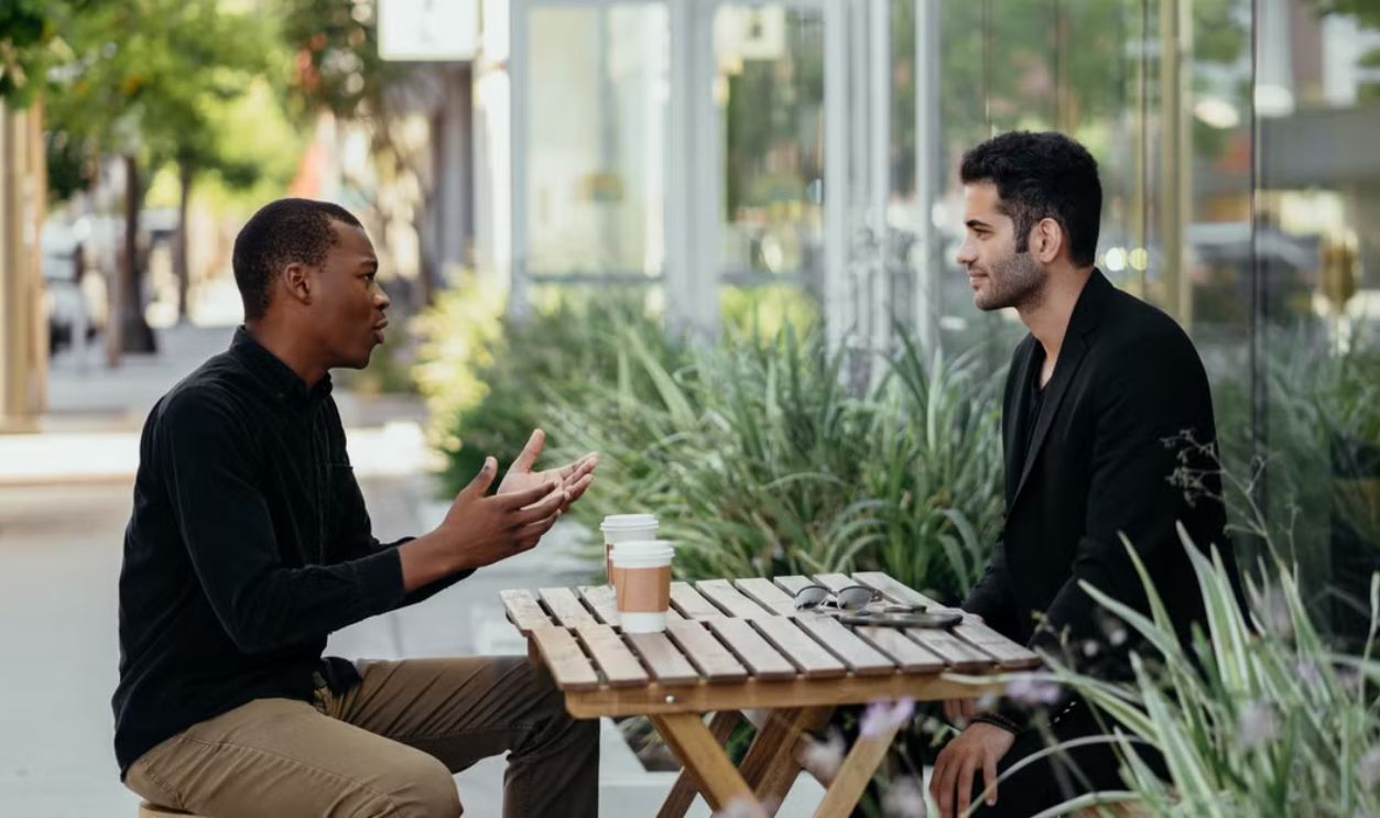 Two men having a business meeting at an outdoor cafe setting