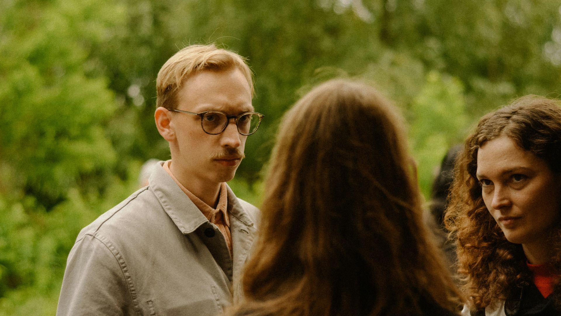 a group of people standing around each other