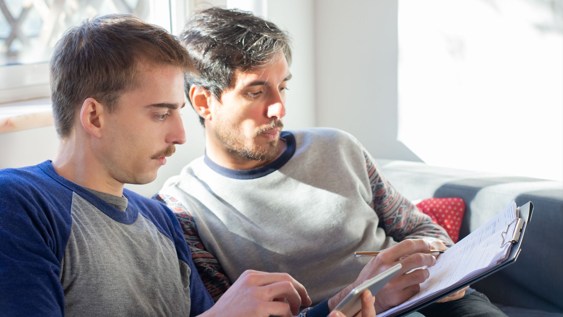 A close-up of a same-sex couple enjoying time together at home in Portugal.