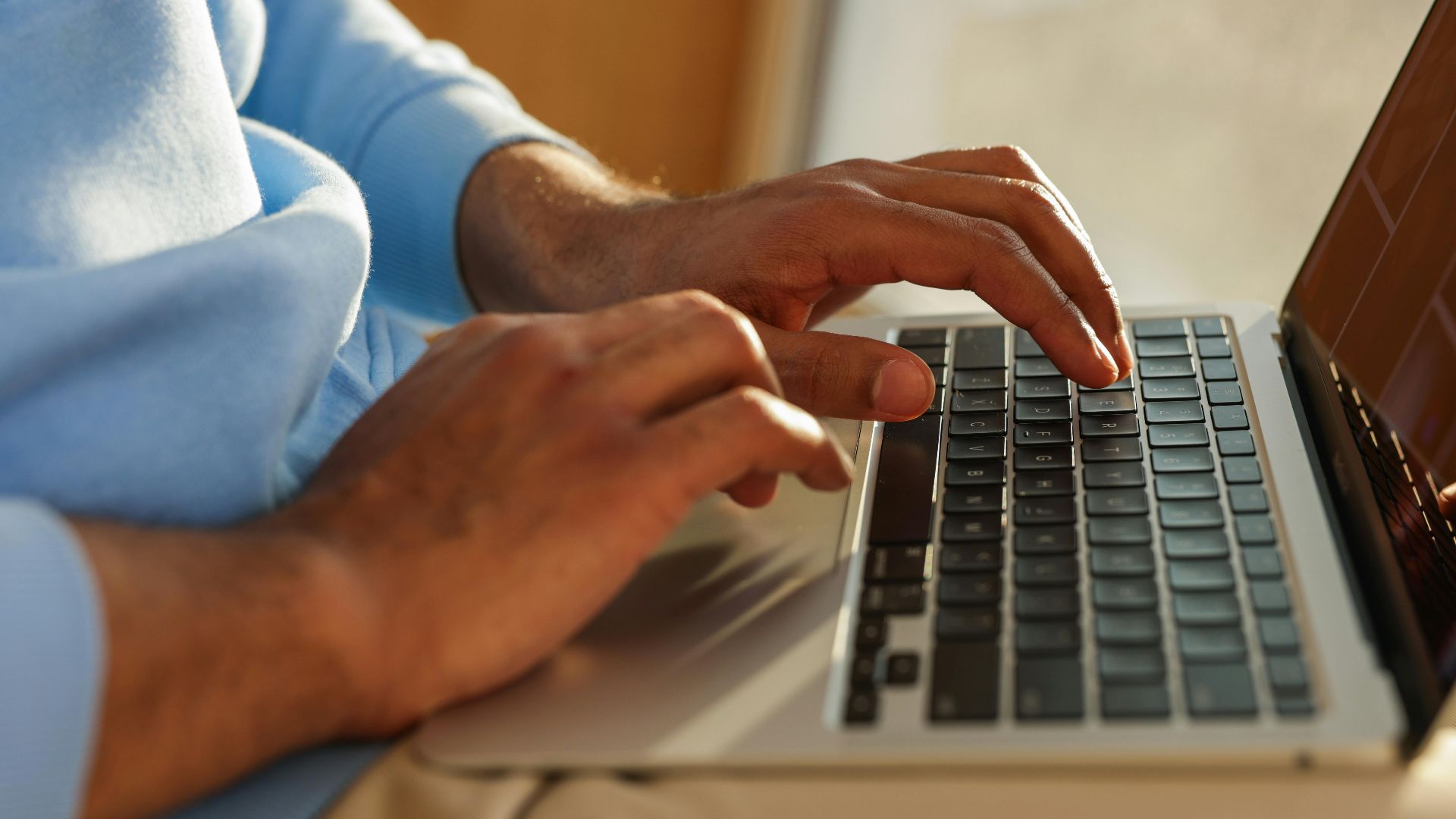 Focused image of hands typing on a laptop, ideal for business and tech themes.