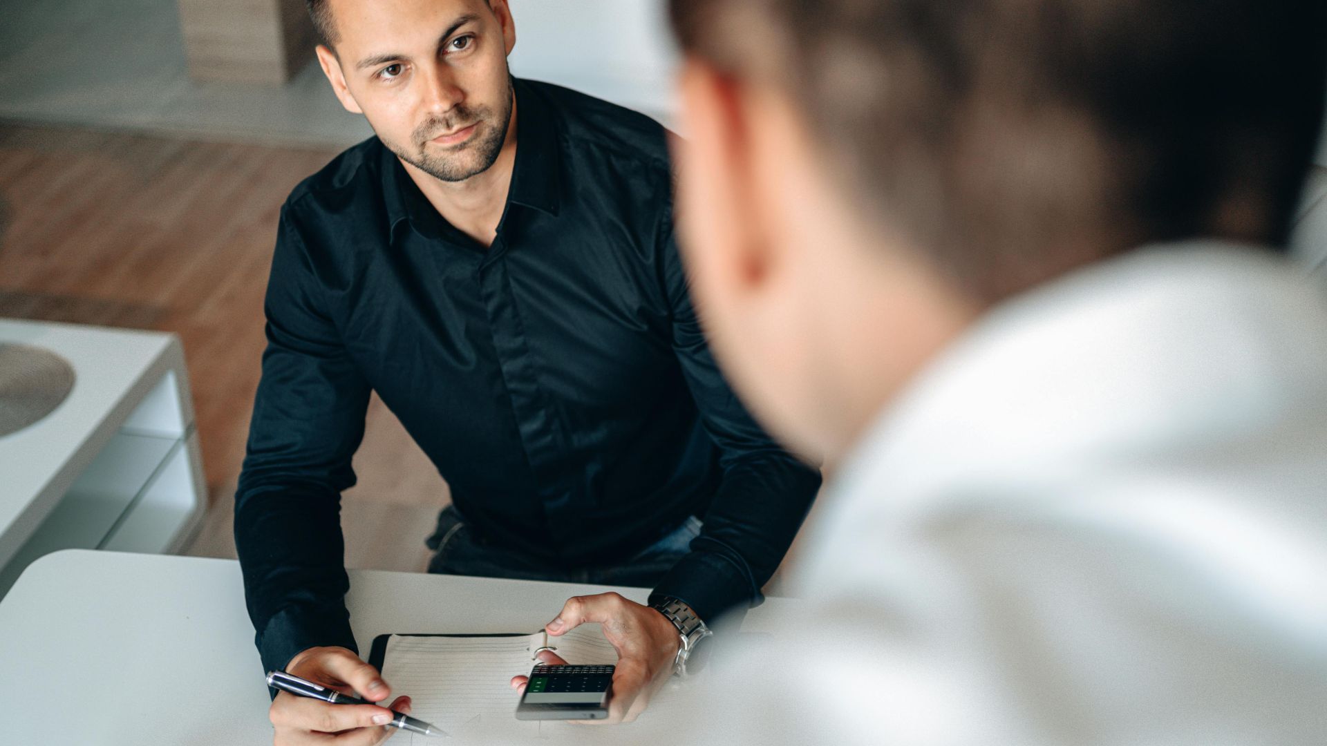 Men collaborating in an office setting, focused on planning and strategy.
