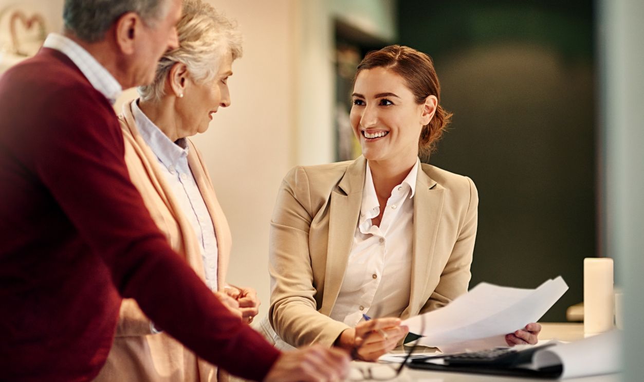 Senior couple, lawyer and documents in discussion for budget or retirement plan at home. Happy elderly man and woman with consultant or financial advisor and paperwork for investment planning or loan