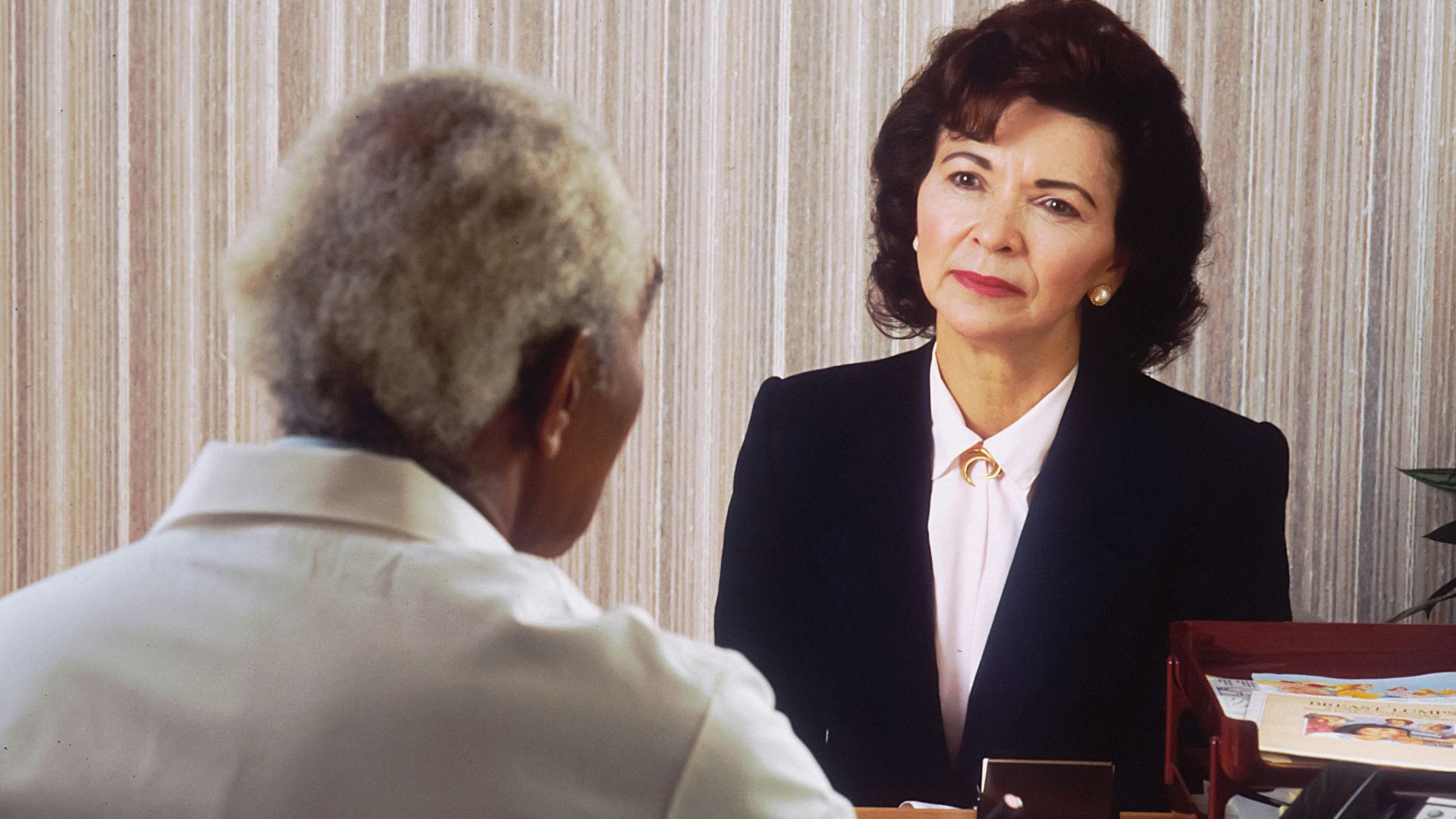 man in black suit jacket standing beside woman in white dress shirt