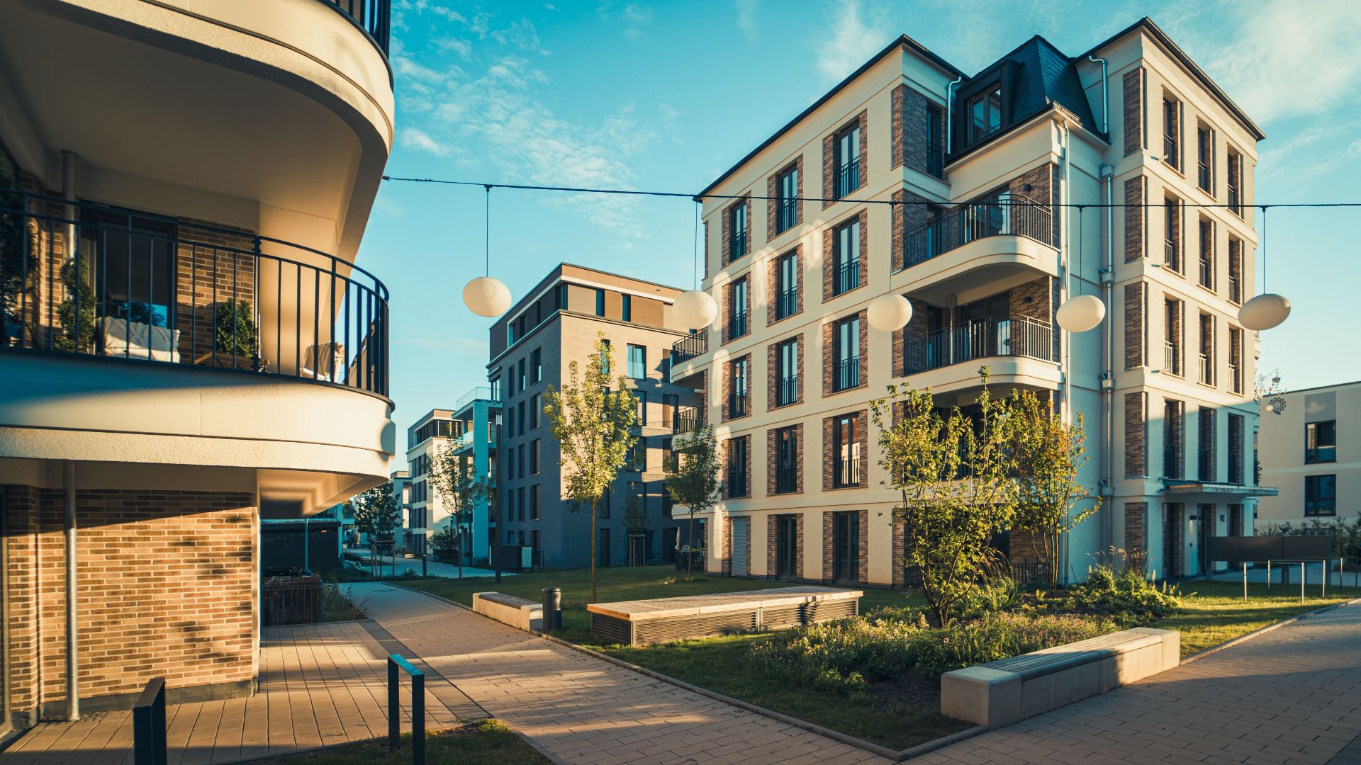 Contemporary urban housing complex showcasing modern architecture and open balconies in daylight.