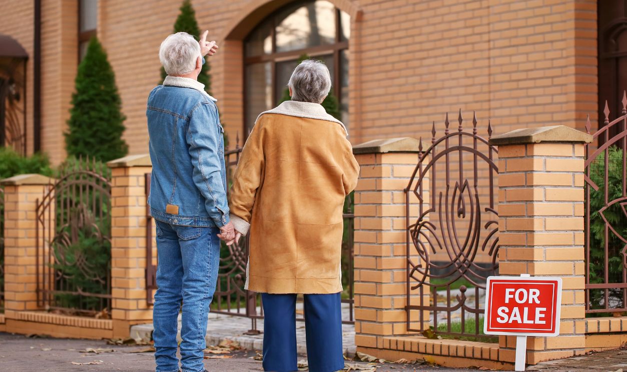 Senior couple near their new house