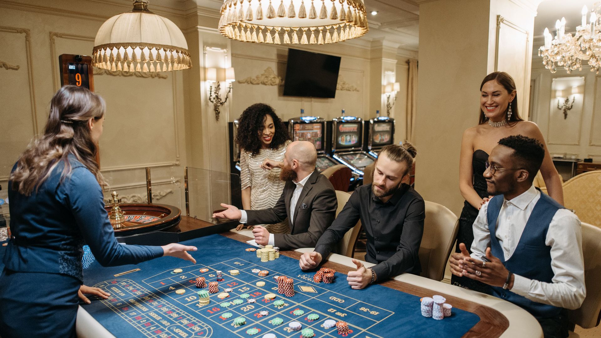 Group of people enjoying a lively night at the casino, playing roulette.
