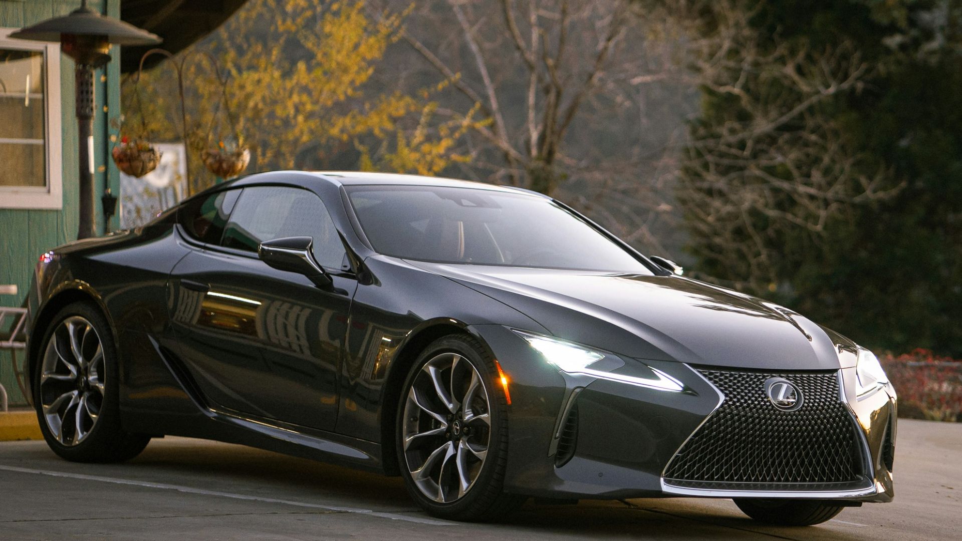 gray Lexus coupe parked in front of building