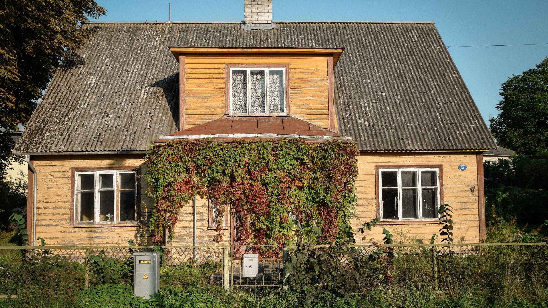 A vintage wooden house with ivy-clad facade in a peaceful Kuressaare neighborhood, Estonia.