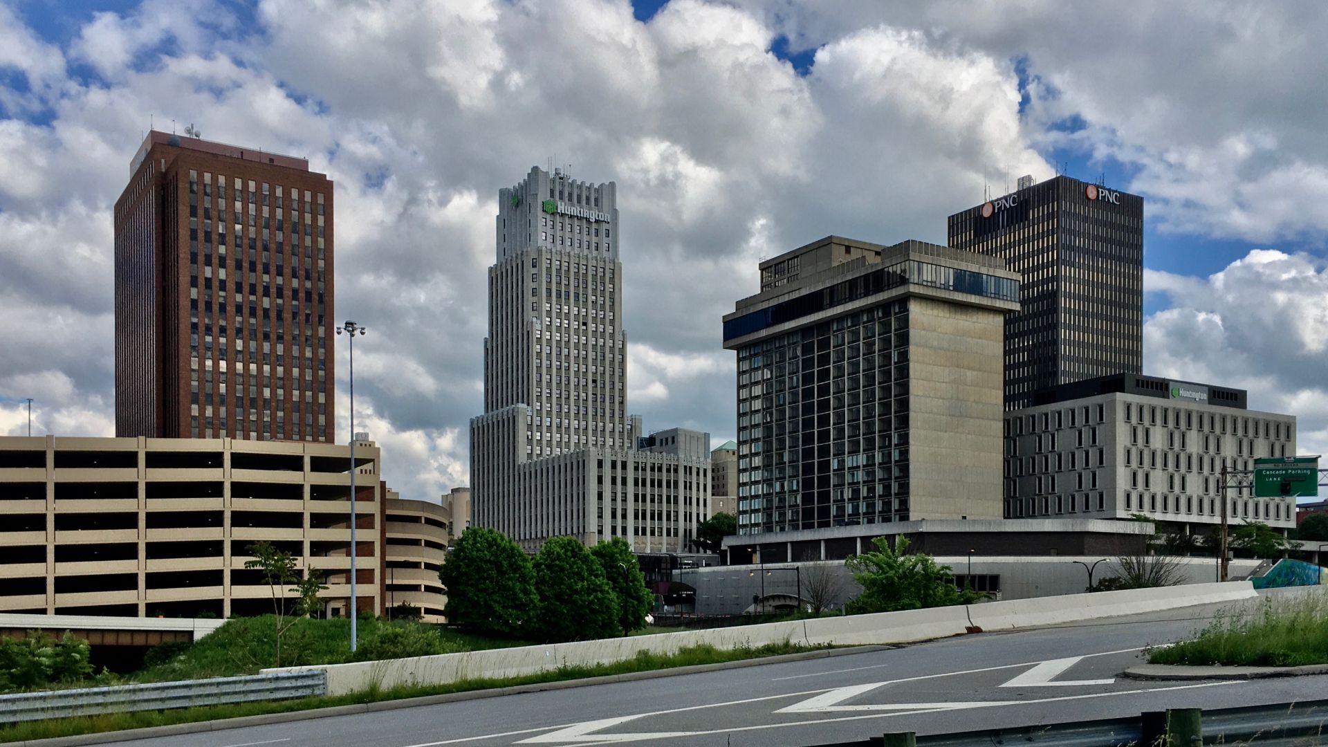 Part of the skyline of Akron, Ohio as seen from the Ohio & Erie Canalway Trail on the north side of Martin Luther King Boulevard (State Route 59) in May 2020. Left to right: FirstEnergy Building, Huntington Tower, City Centre Hotel, PNC Center, Three Casc