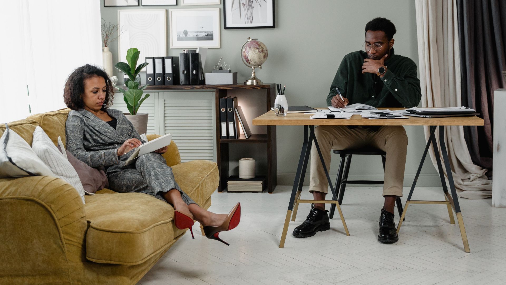 Contemporary office scene with professionals discussing and reading.