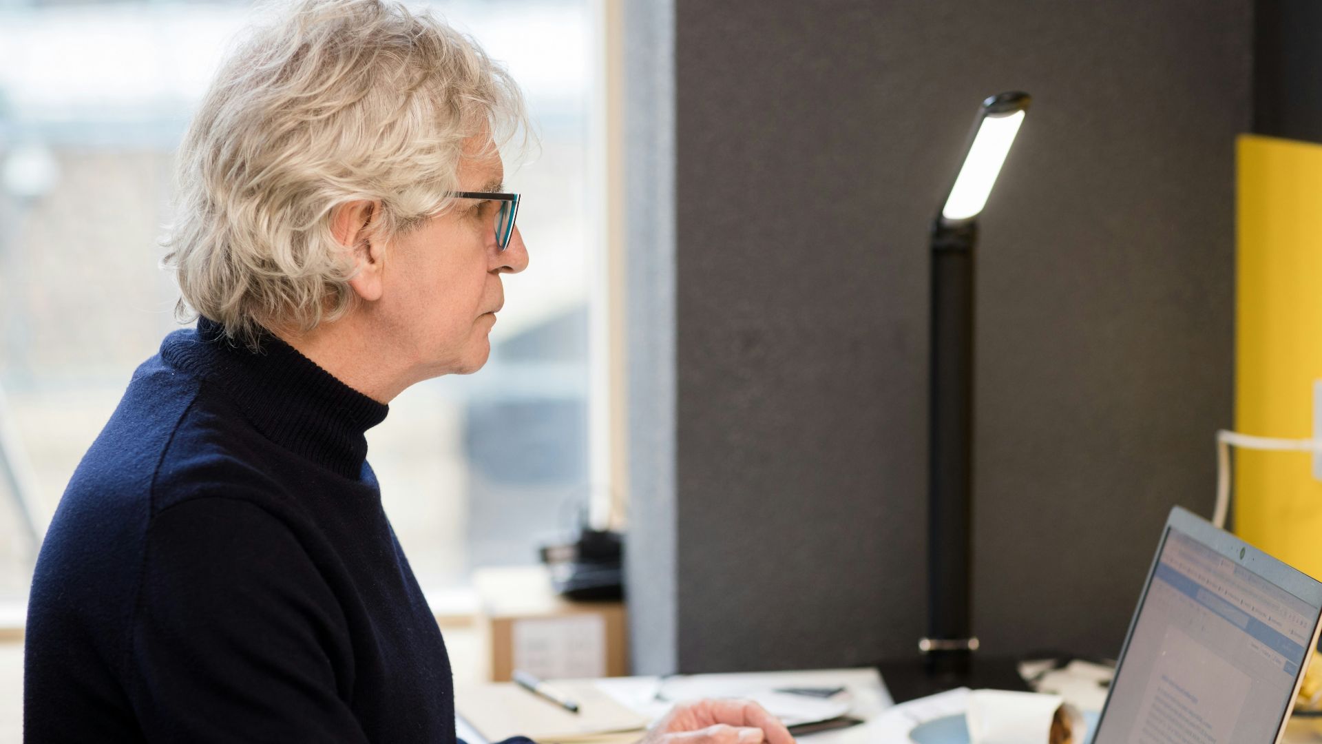 a woman sitting in front of a laptop computer