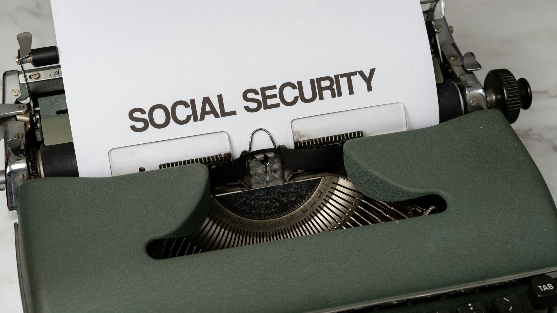 a close up of a typewriter with a paper that says social security