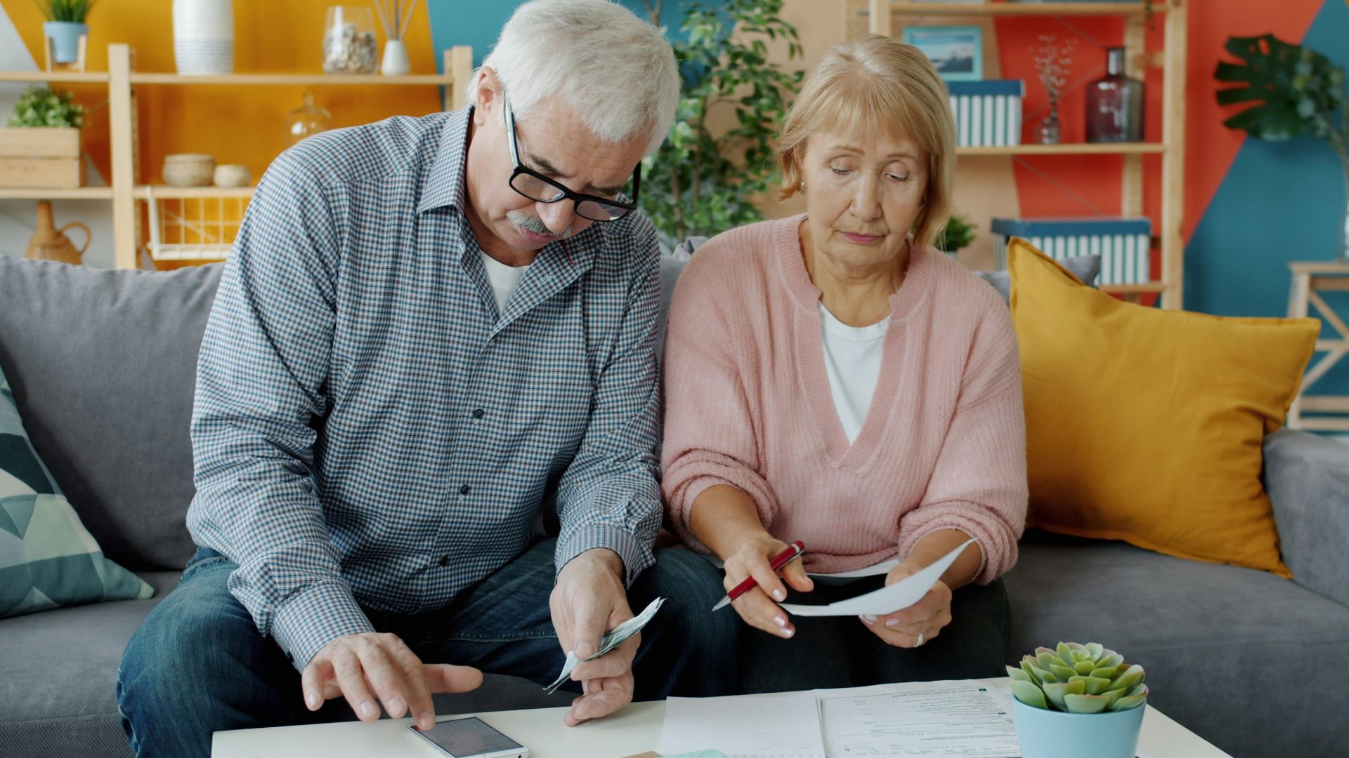 Elderly couple reviewing documents at home