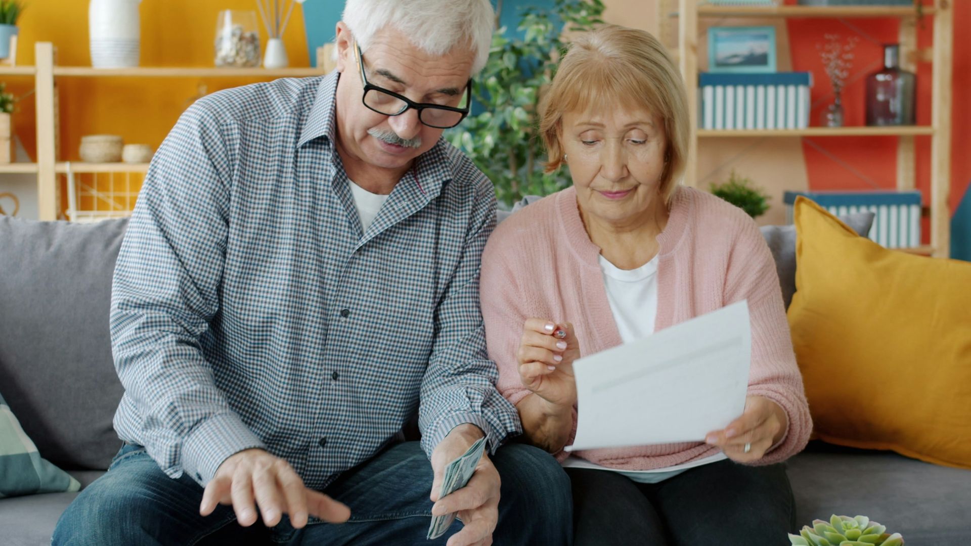 Elderly couple reviewing documents at home