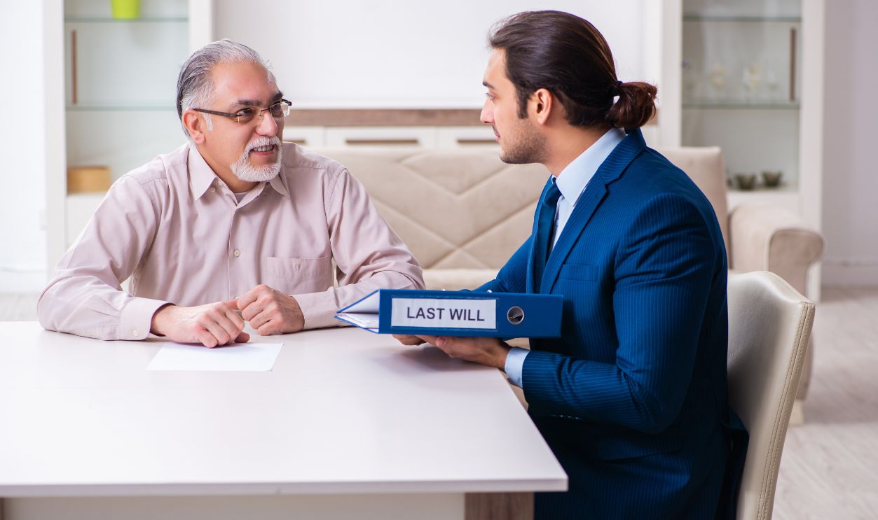 Young male lawyer visiting old man in testament concept