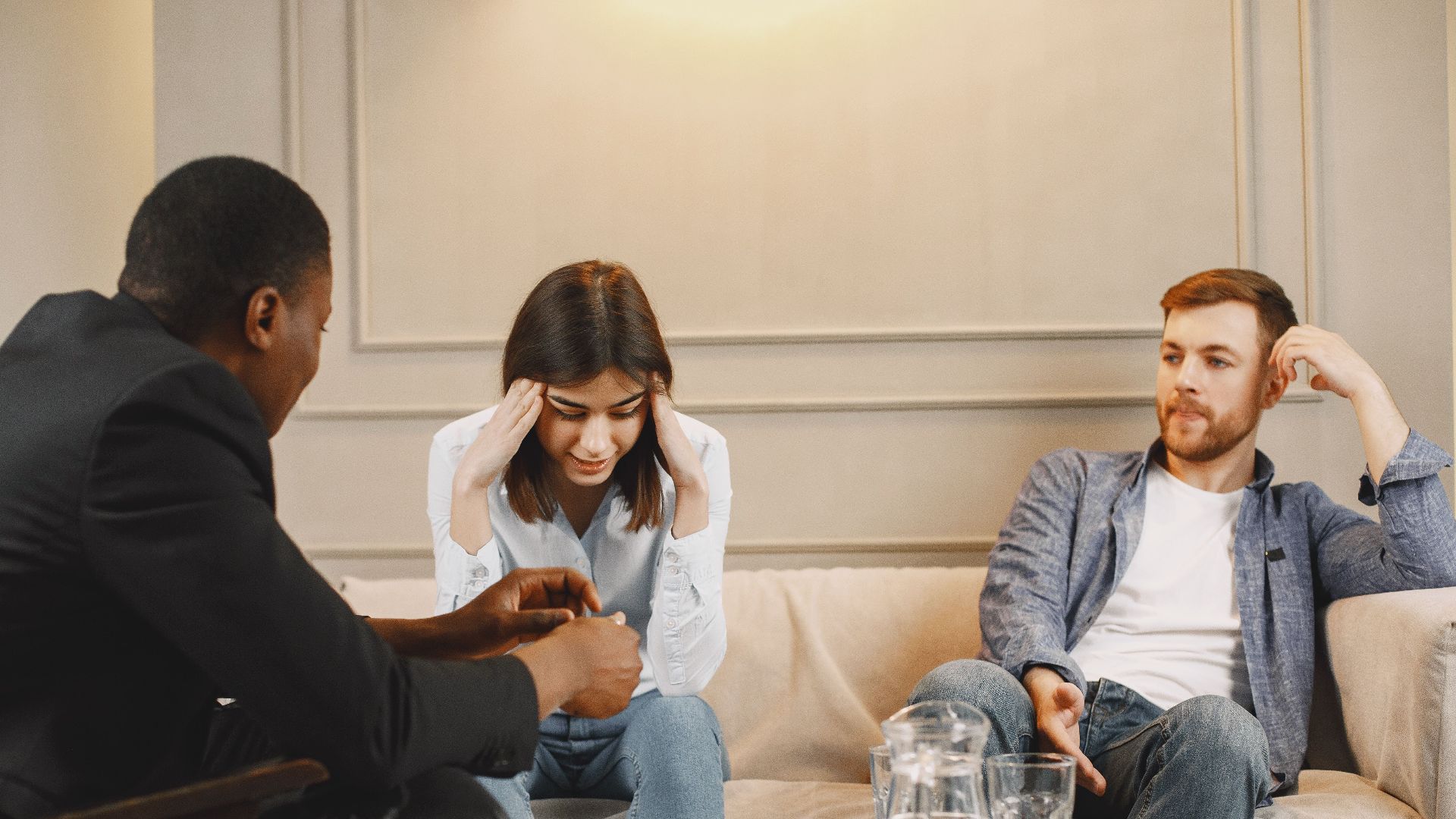 A couple attending a counseling session with a therapist, discussing their issues.