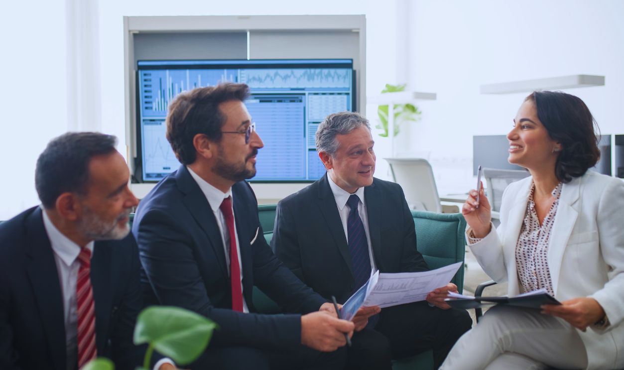 Diverse business professionals engaged in a lively office meeting, fostering collaboration and teamwork