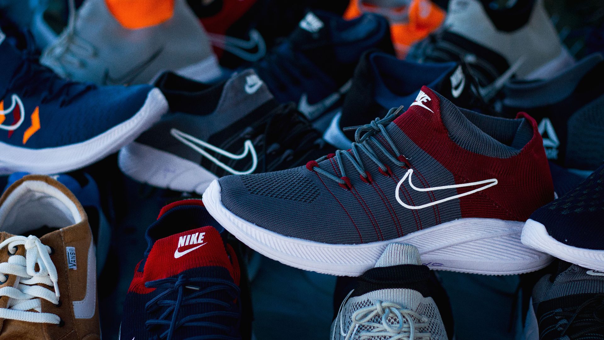 Diverse array of athletic shoes showcased in vibrant colors and various styles.