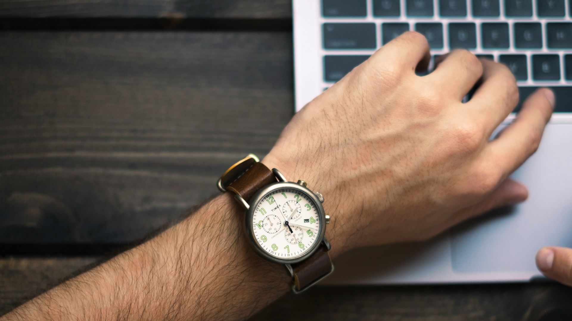 person wearing brown and white watch