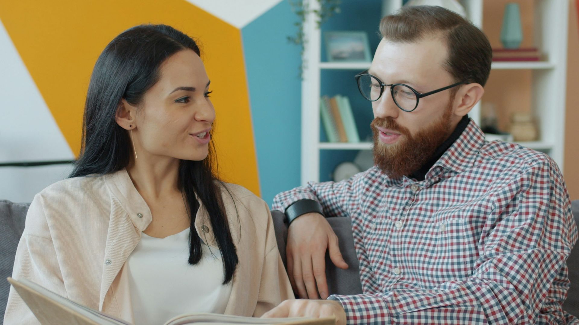 Couple looking at an open photo album together