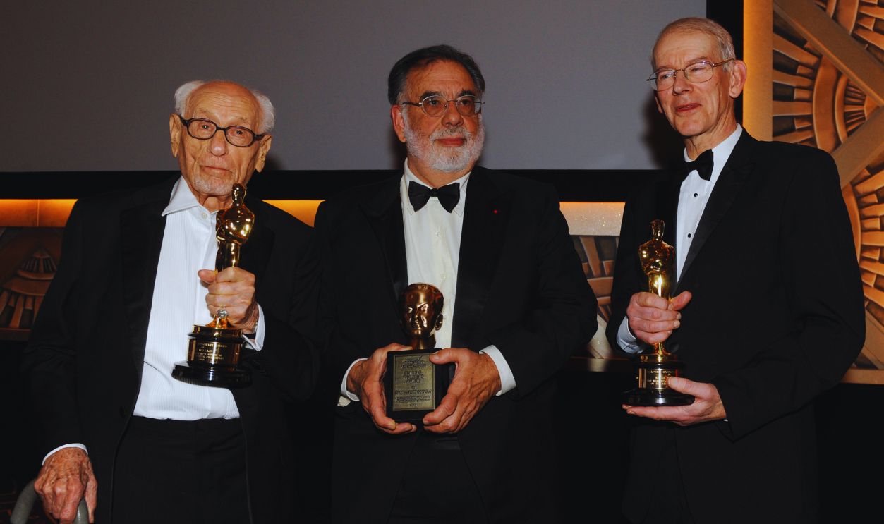 Gettyimages - 106819160, Director Francis Ford Coppola (C) holds his Irving G. Thalberg Memorial Award, or Thalberg bust, as Actor Eli Wallach (L) and Film Historian and Preservationist Kevin Barlow (R) hold their Honorary Awards, or Oscar Statuettes, at the 2010 Oscars Governors Awards at the Hollywood and Highland Center in Hollywood on November 13, 2010.
