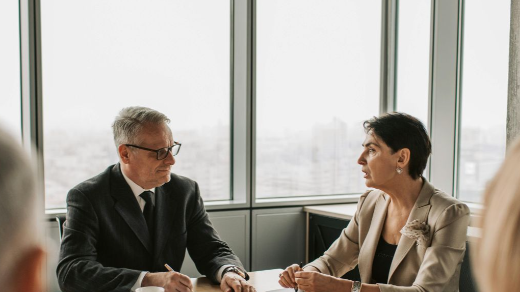 Man and woman discussing business in a meeting