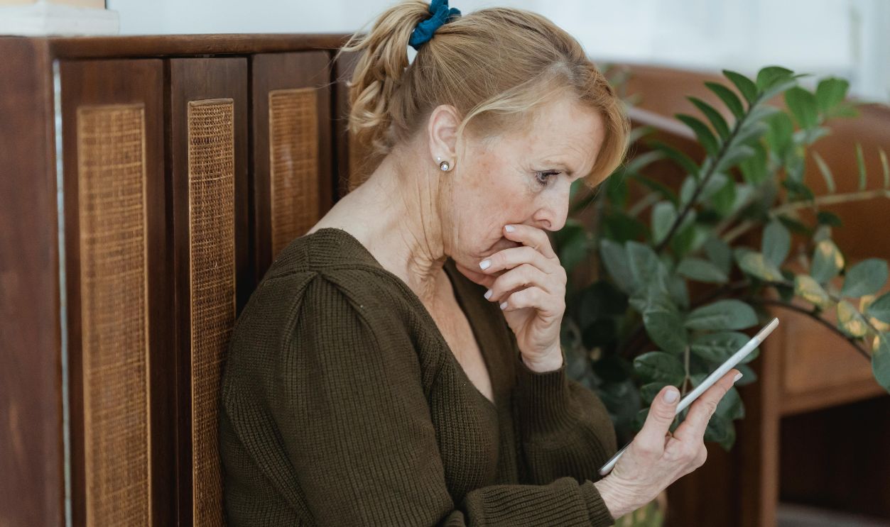 Senior woman deeply focused on her smartphone