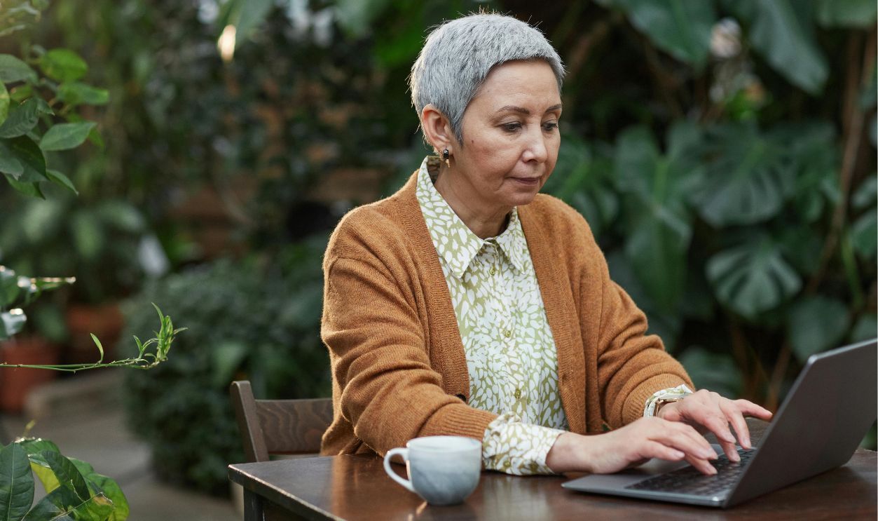 An elderly woman using a laptop 