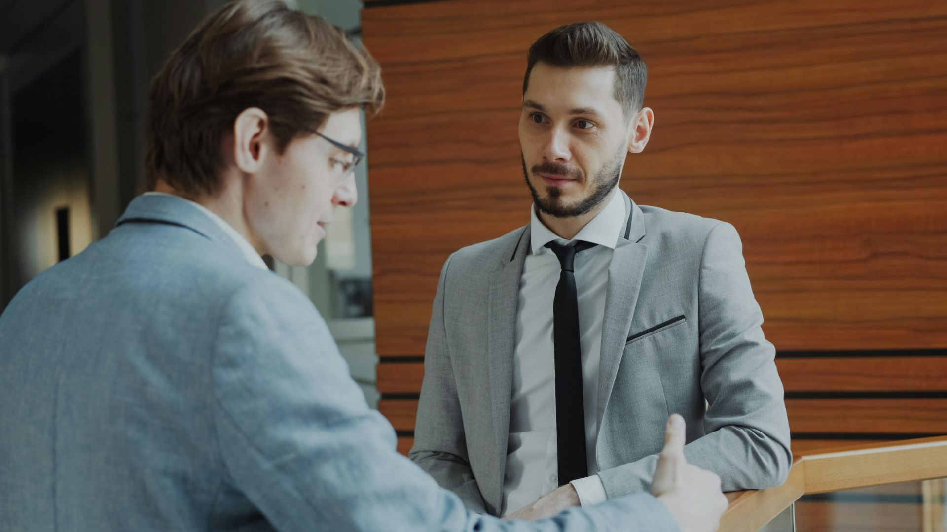 Two businessmen shaking hands in modern office