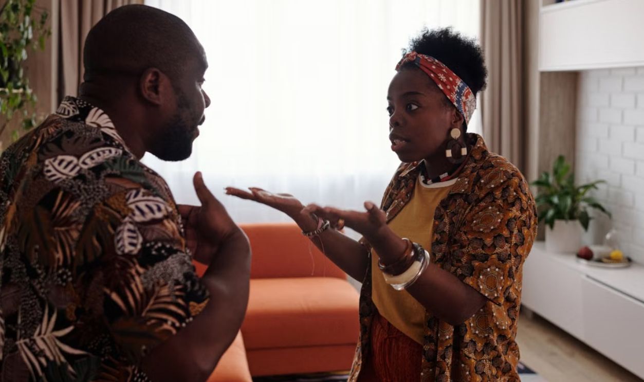 A couple arguing passionately in their living room, expressing emotions and gestures